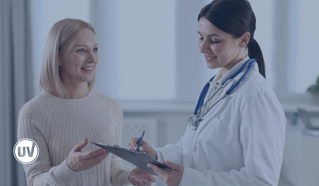 Fibroid doctor discussing symptoms with patient for fibroid monitoring appointment