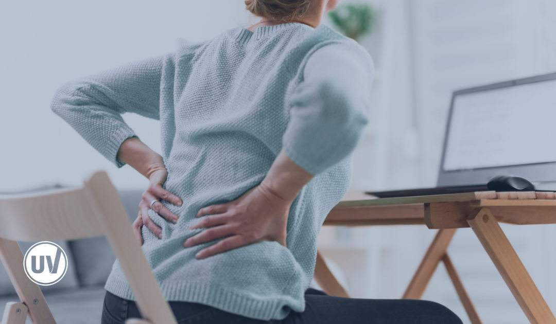 Woman experiencing back pain due to uterine fibroids