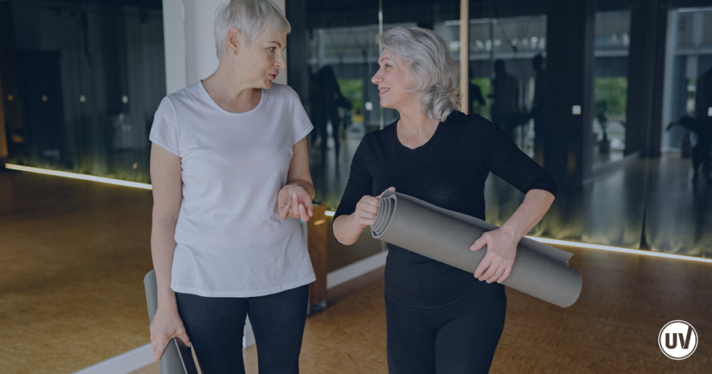 Older women leaving a yoga class, showing how exercise can help alleviate fibroid pain in your later years